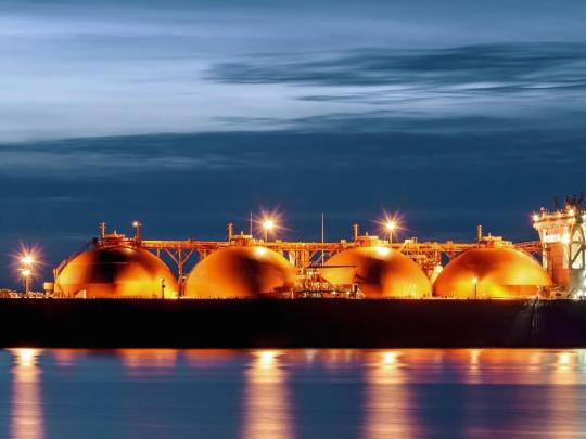 Liquified natural gas tanker on the water at sunset